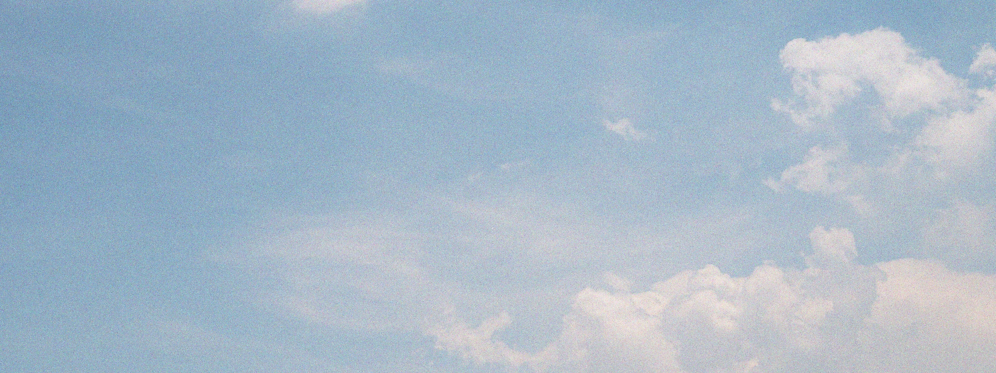 Clear blue sky with a few scattered clouds